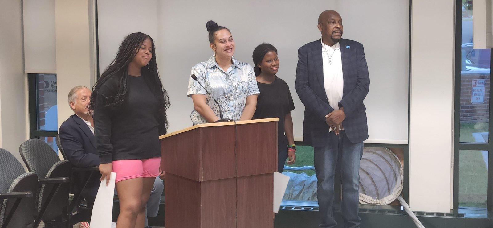 CCWW youth speaking at a podium during a public meeting